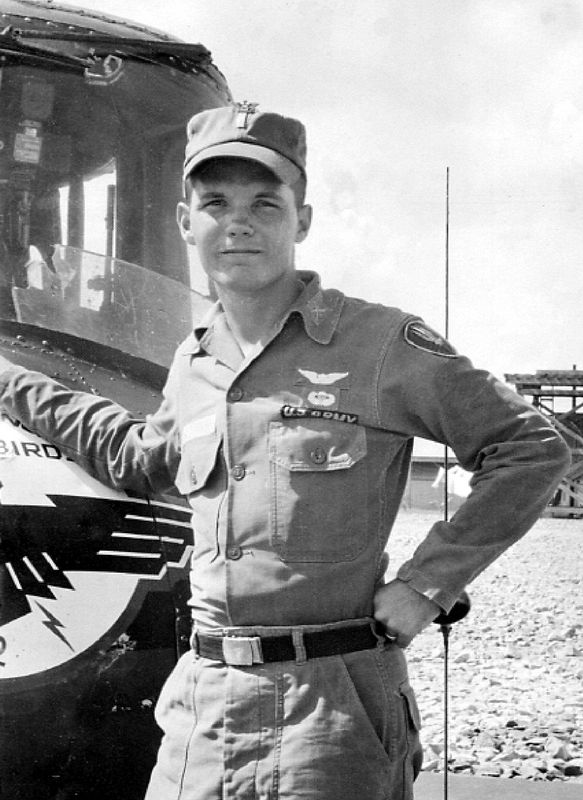 1LT Stewart poses in front of his helicopter gun ship. Note the bullet hole in the nose of the aircraft and the previous battle damage to the âtipping plateâ in the windshield.