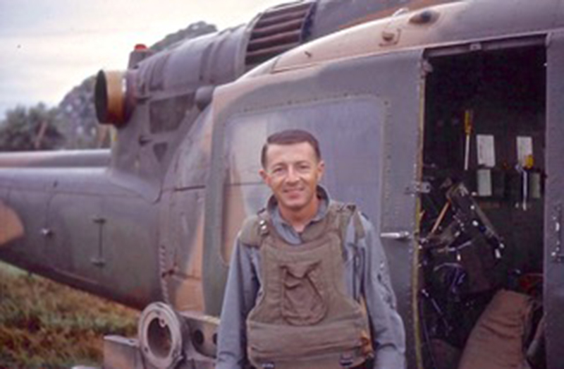 Captain Viviano wearing armor next to his gunship